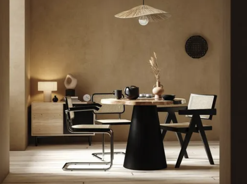 A dining room scene, with two chairs, a pendant light hanging central